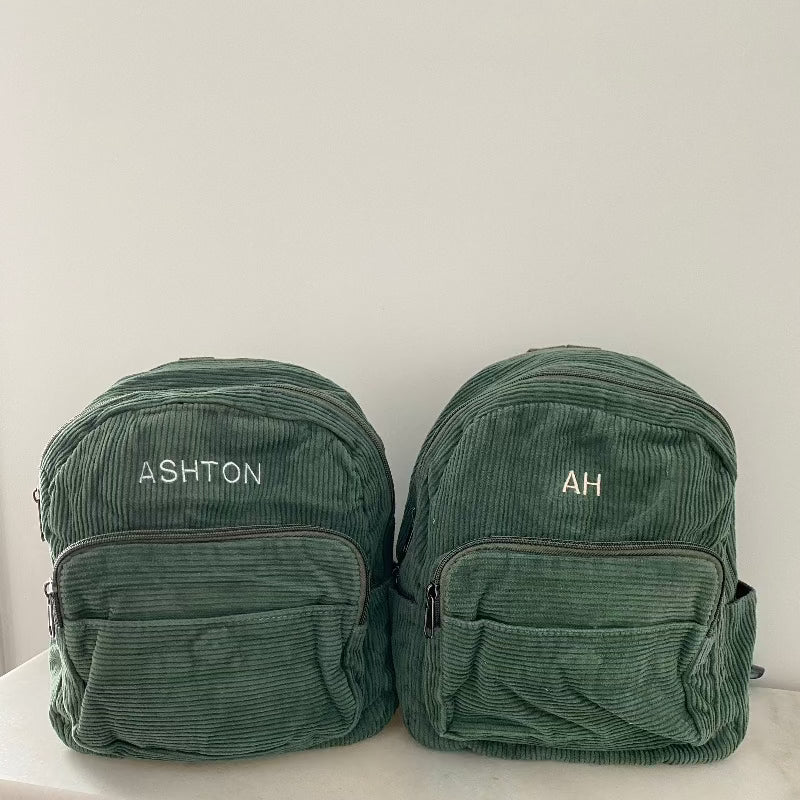 forest green bag with white and peach thread